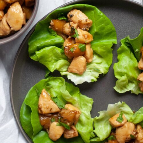 Top-down shot of Chicken Mango Lettuce Wraps on a black stone plate.