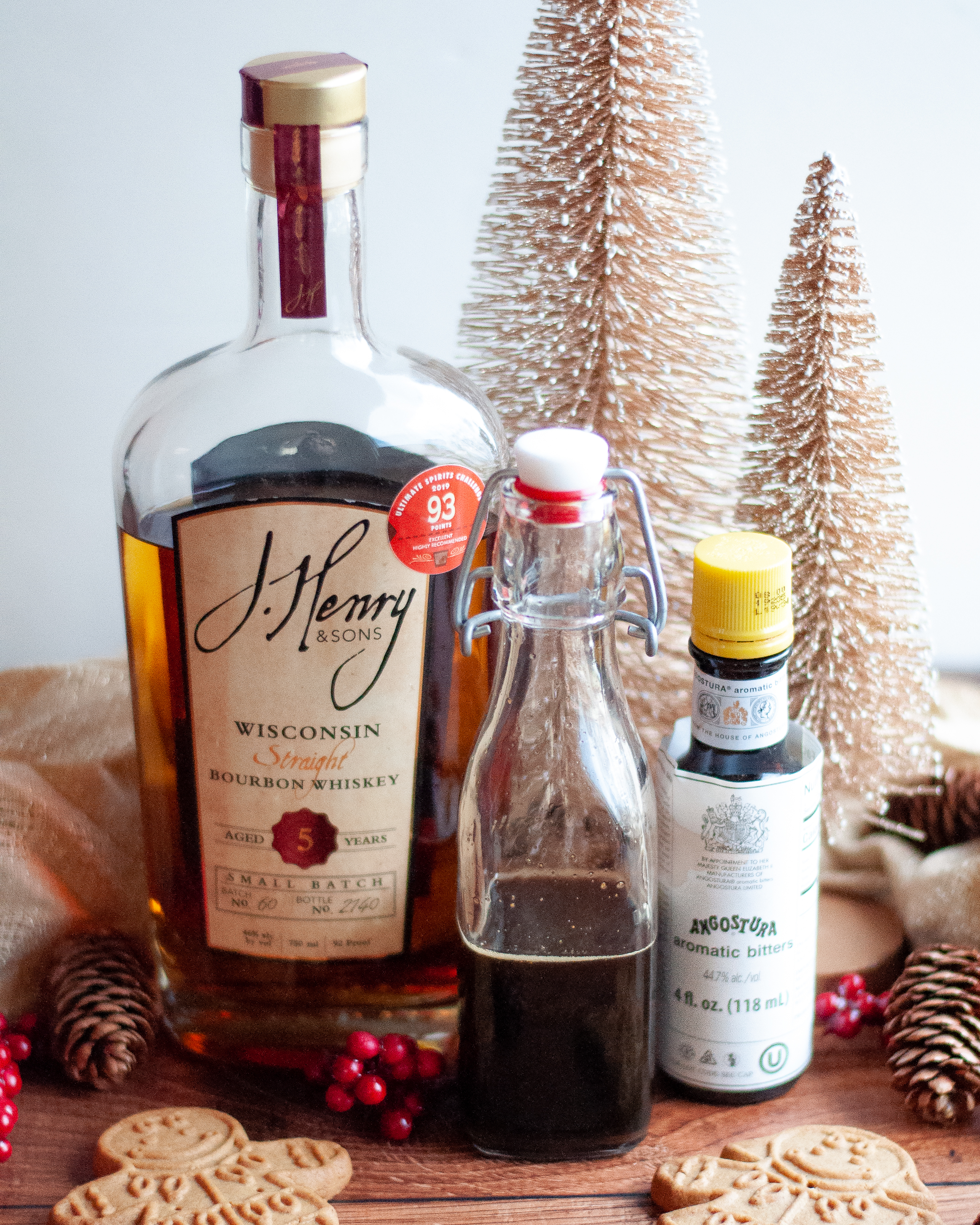 Ingredients for this old fashioned recipe, including bourbon, gingerbread simple syrup, and bitters.