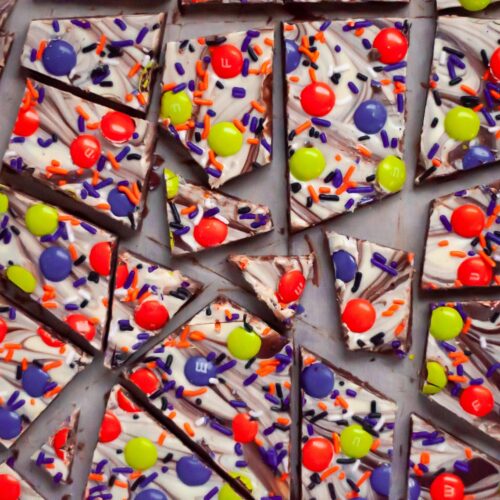top down view of various sized pieces of Halloween Chocolate Bark with Sprinkles.