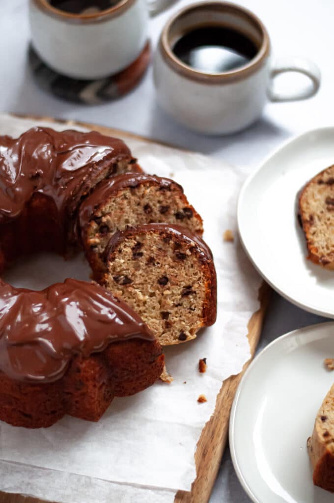 Sliced banana chocolate chip bundt cake with chocolate glaze, showcasing the lovely texture on each of the slices.