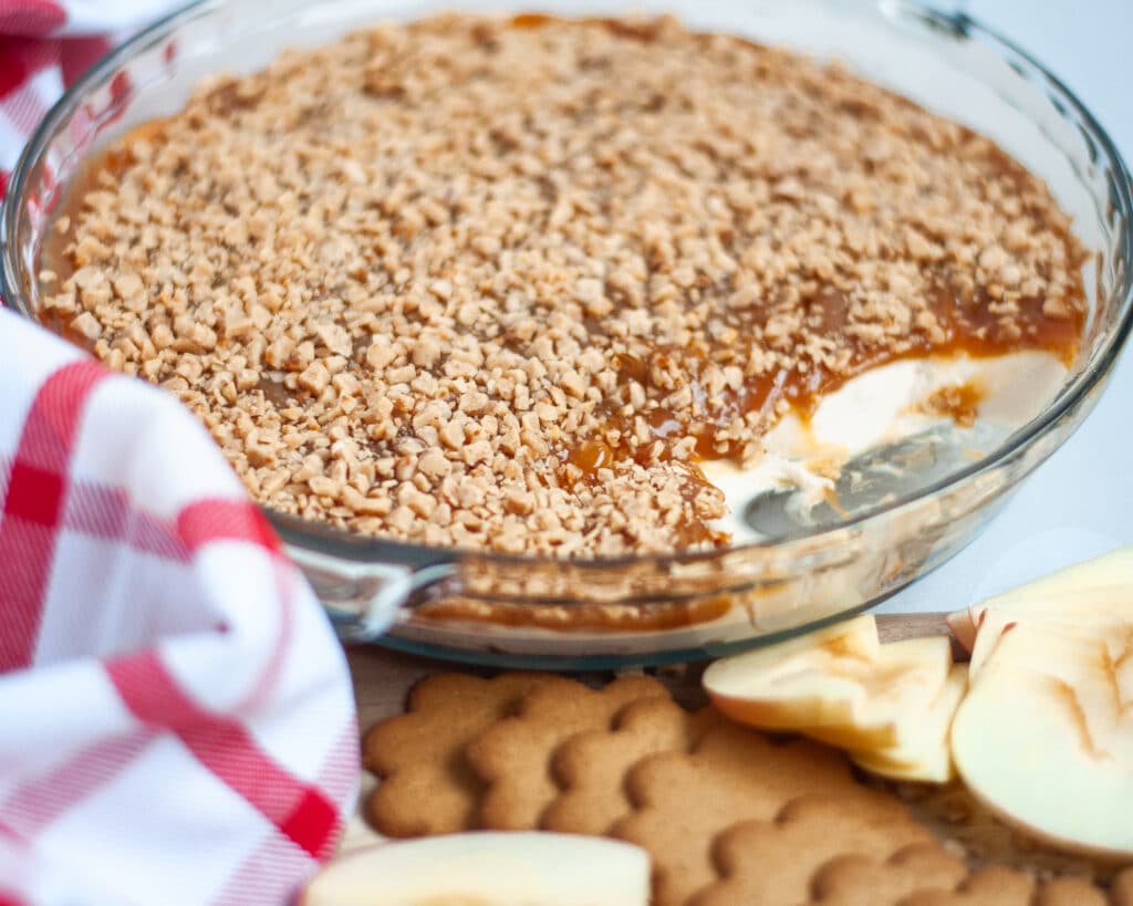 Close up of a section of the pie pan, already dunked into, showing the layers of this easy dessert dip recipe.