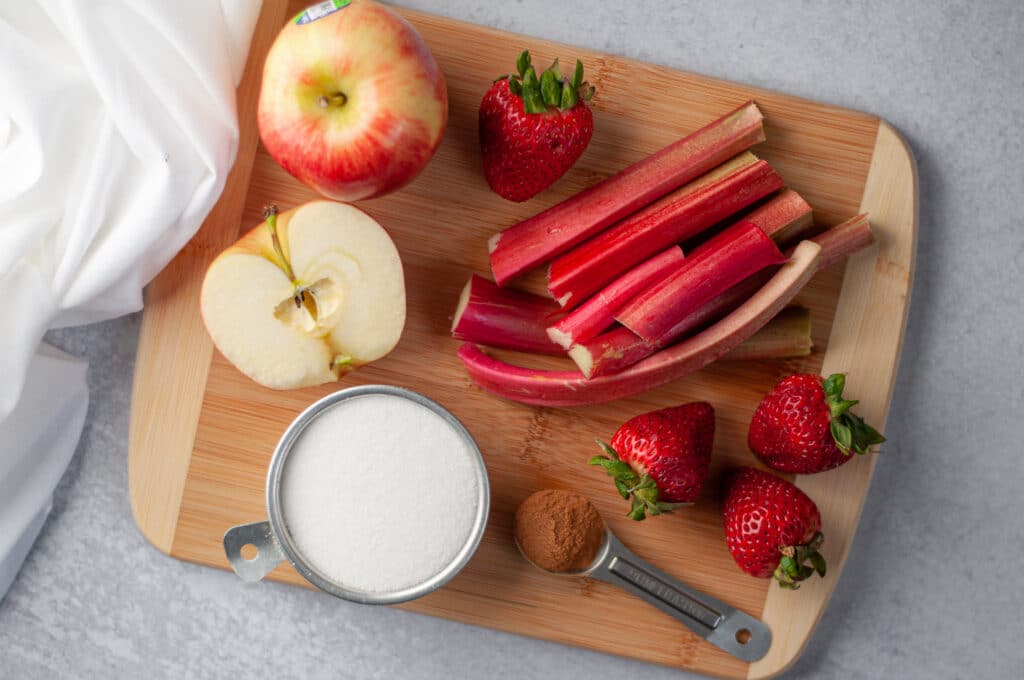 Ingredients for this rhubarb compote recipe on a cutting board.