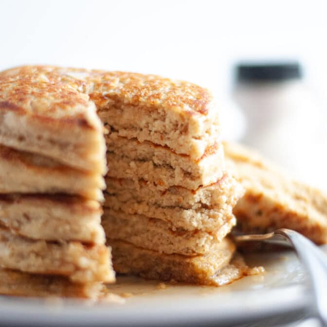 stack of protein pancakes without banana. these easy blender pancakes have a slice cut out of them and are ready to eat!
