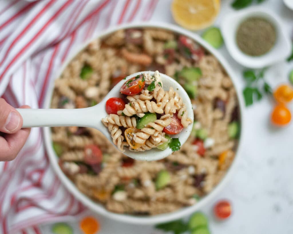 Close up of a serving bowl filled with pasta salad