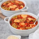 close up of two bowls of tortellini soup