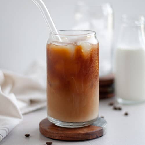 close up of a serving glass of cold brew coffee with milk.