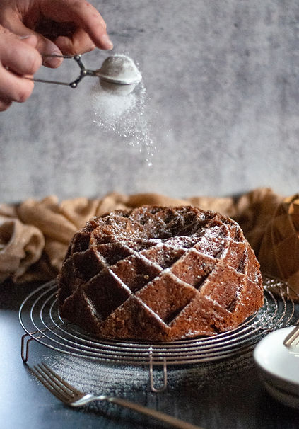 Shaking Powdered Sugar on Chocolate Cake