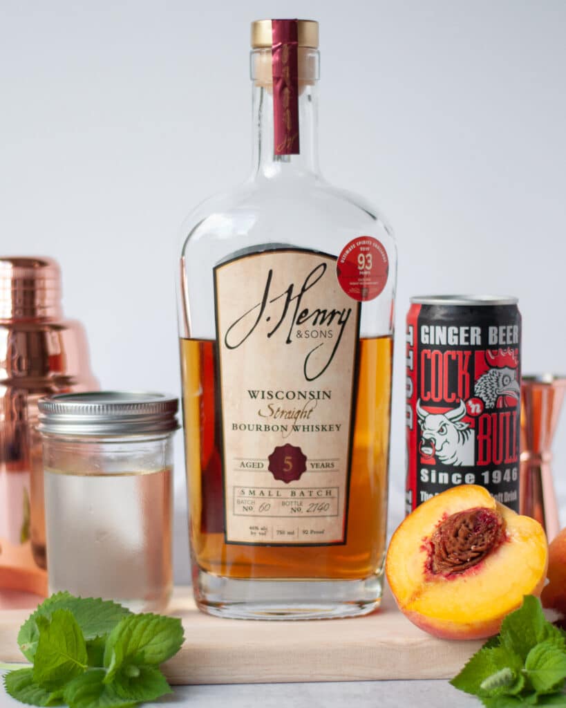 ingredients needed to make a peach bourbon smash cocktail.