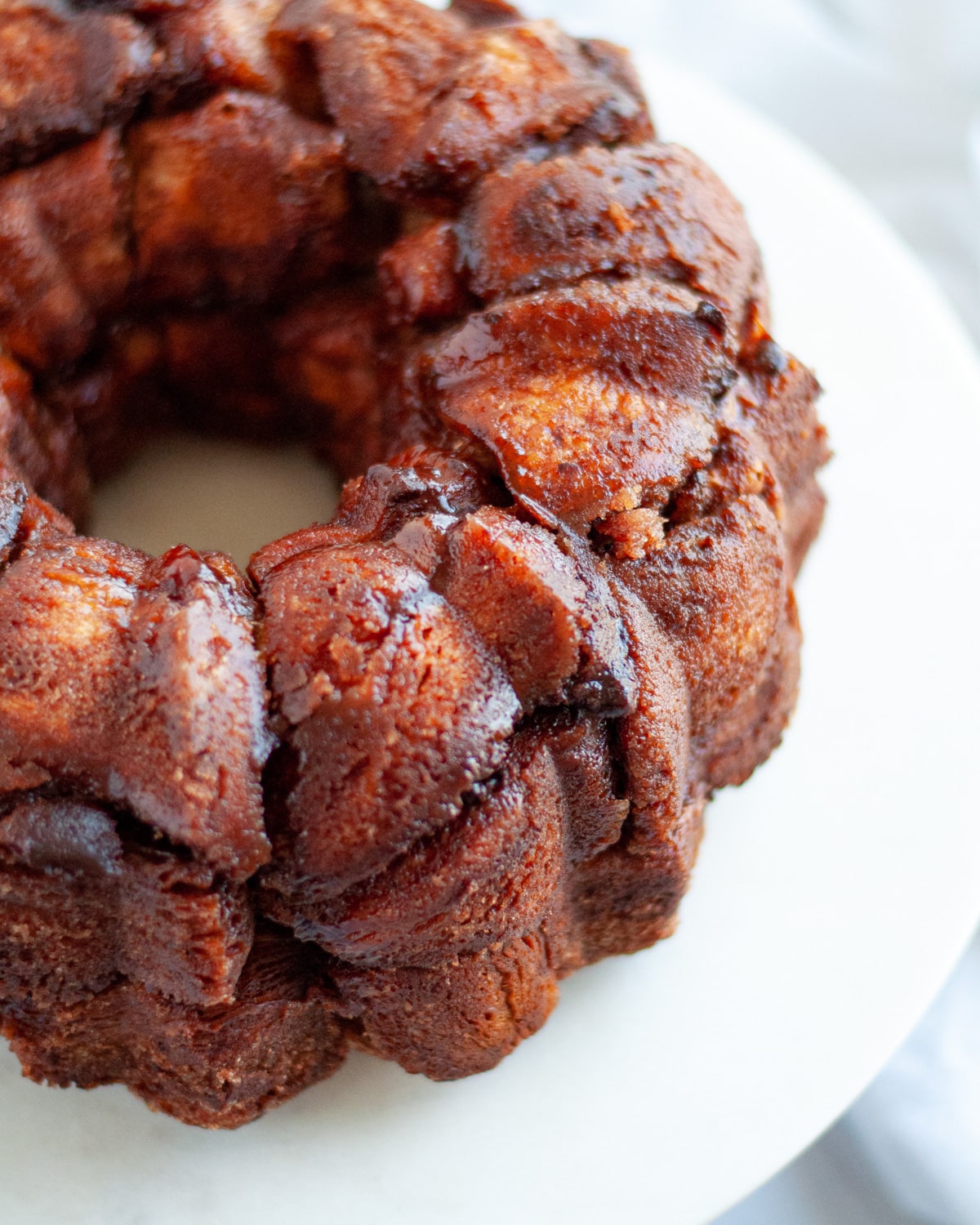 close up of fresh monkey bread just turned out of the bundt pan onto a serving plate.