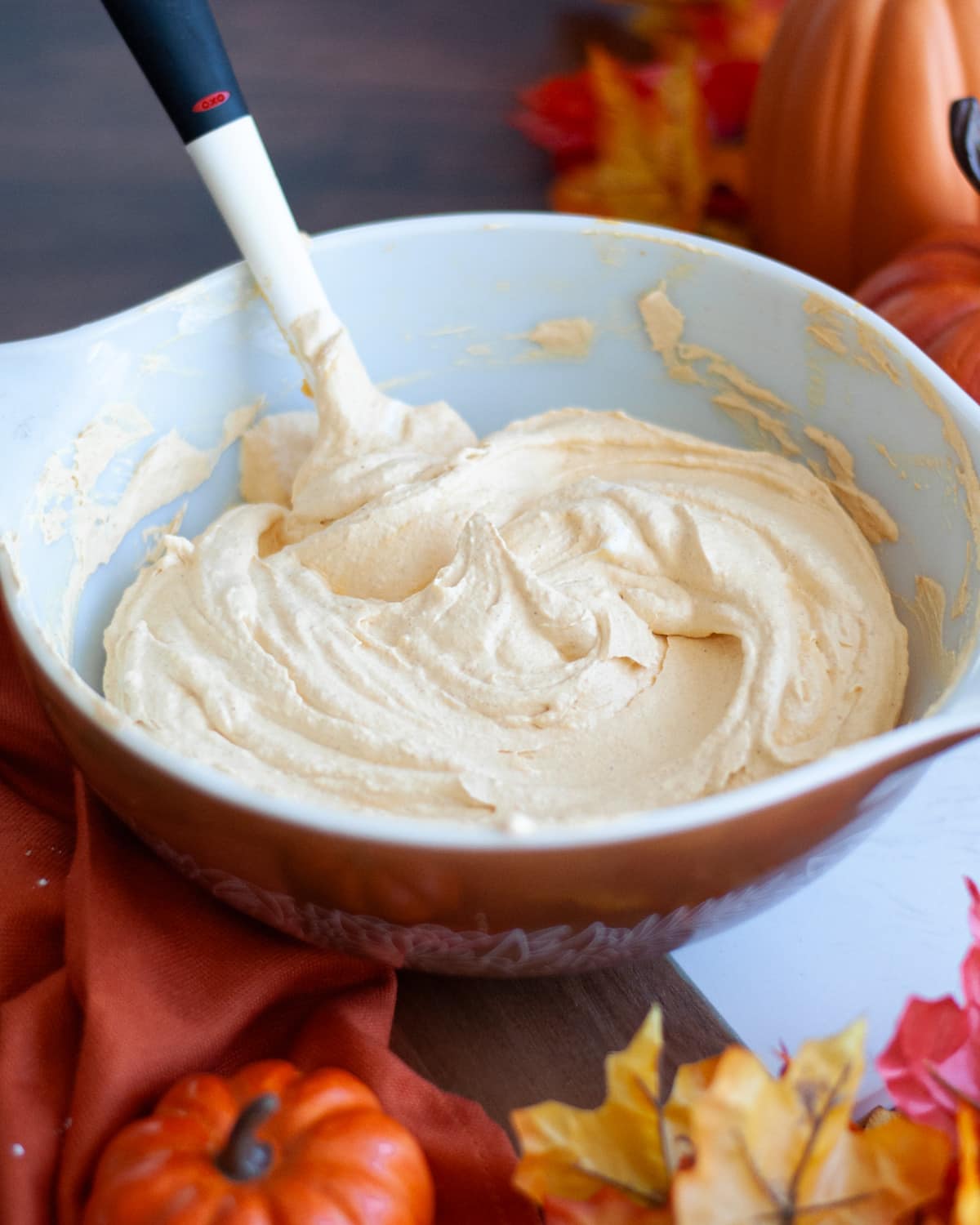 a large mixing bowl filled with freshly mixed pumpkin pie dip.
