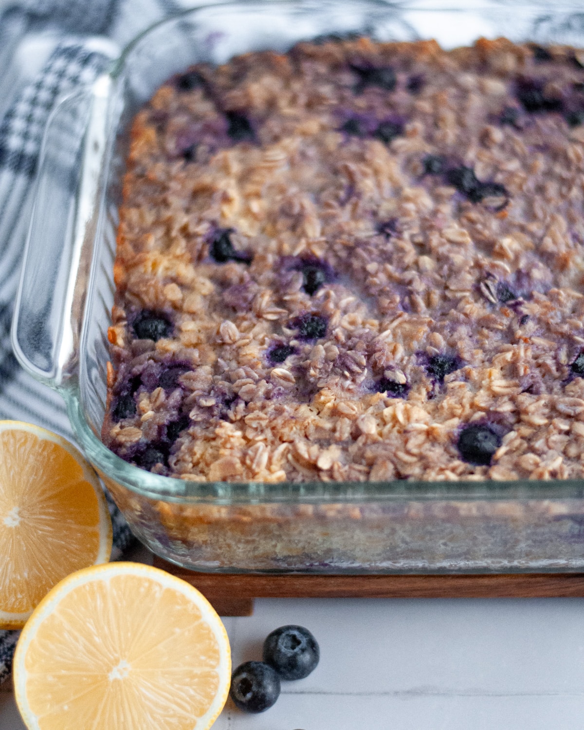 Glass 9x9 baking pan with a golden brown blueberry lemon baked oatmeal fresh out of the oven.