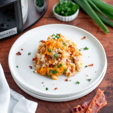 A plate piled high with a hearty scoop of Crockpot Chicken Bacon and Ranch Tater Tot Casserole.