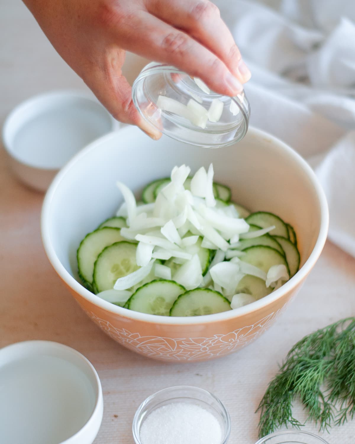 Process shot showing onions being added to the mixing bowl.