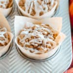 Close up of a pumpkin muffin with streusel topping and vanilla glaze.