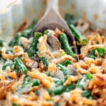 Close up of a serving spoon scooping up the homemade green bean casserole.