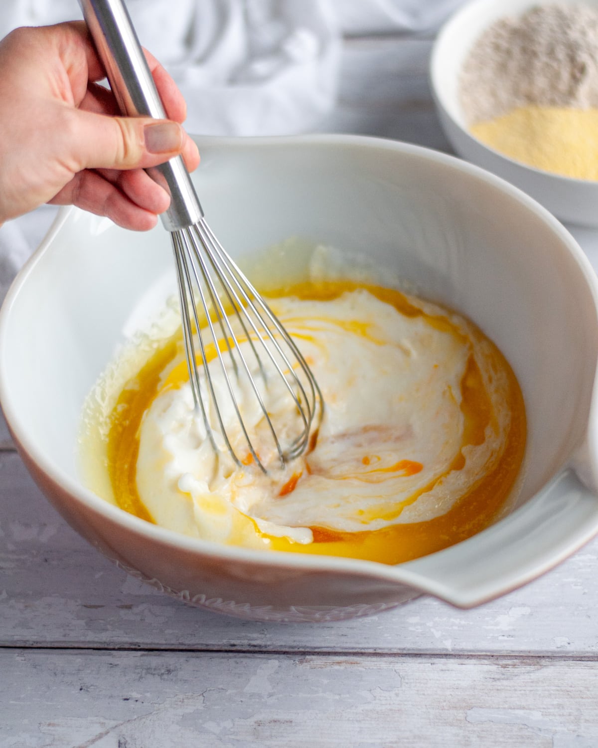 Process shot showing the wet ingredients being whisked together.
