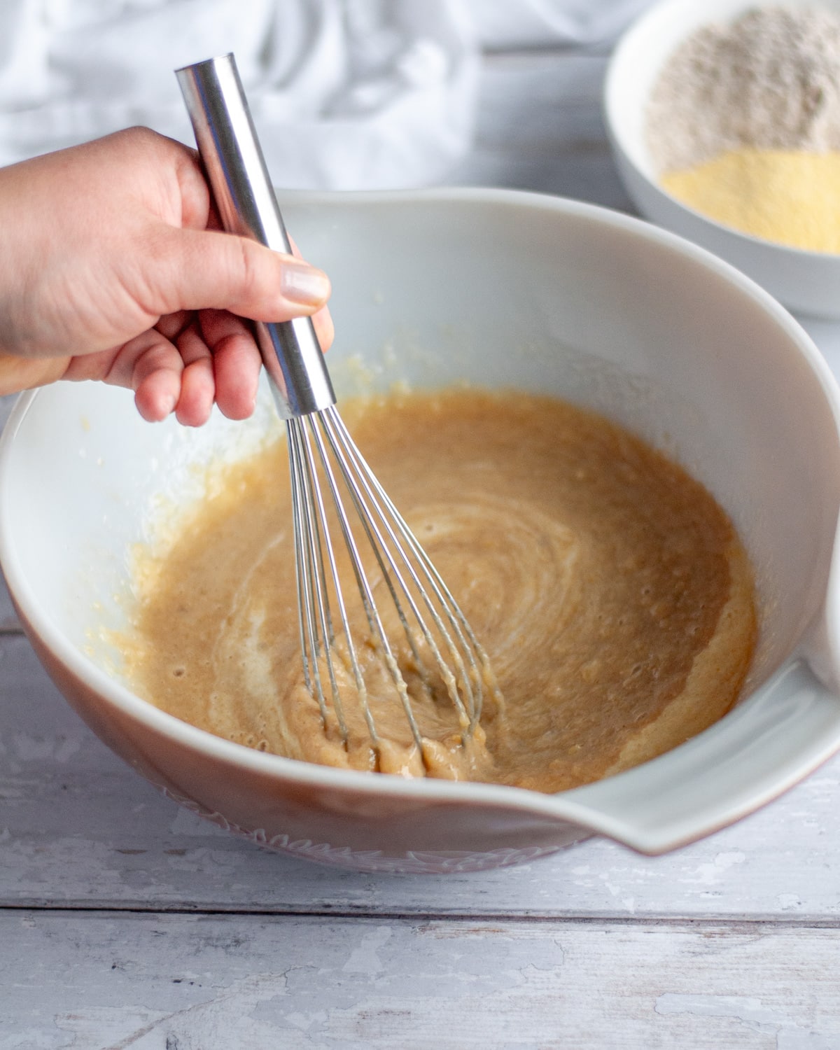 Process shot showing the brown sugar being whisked into the wet ingredients.