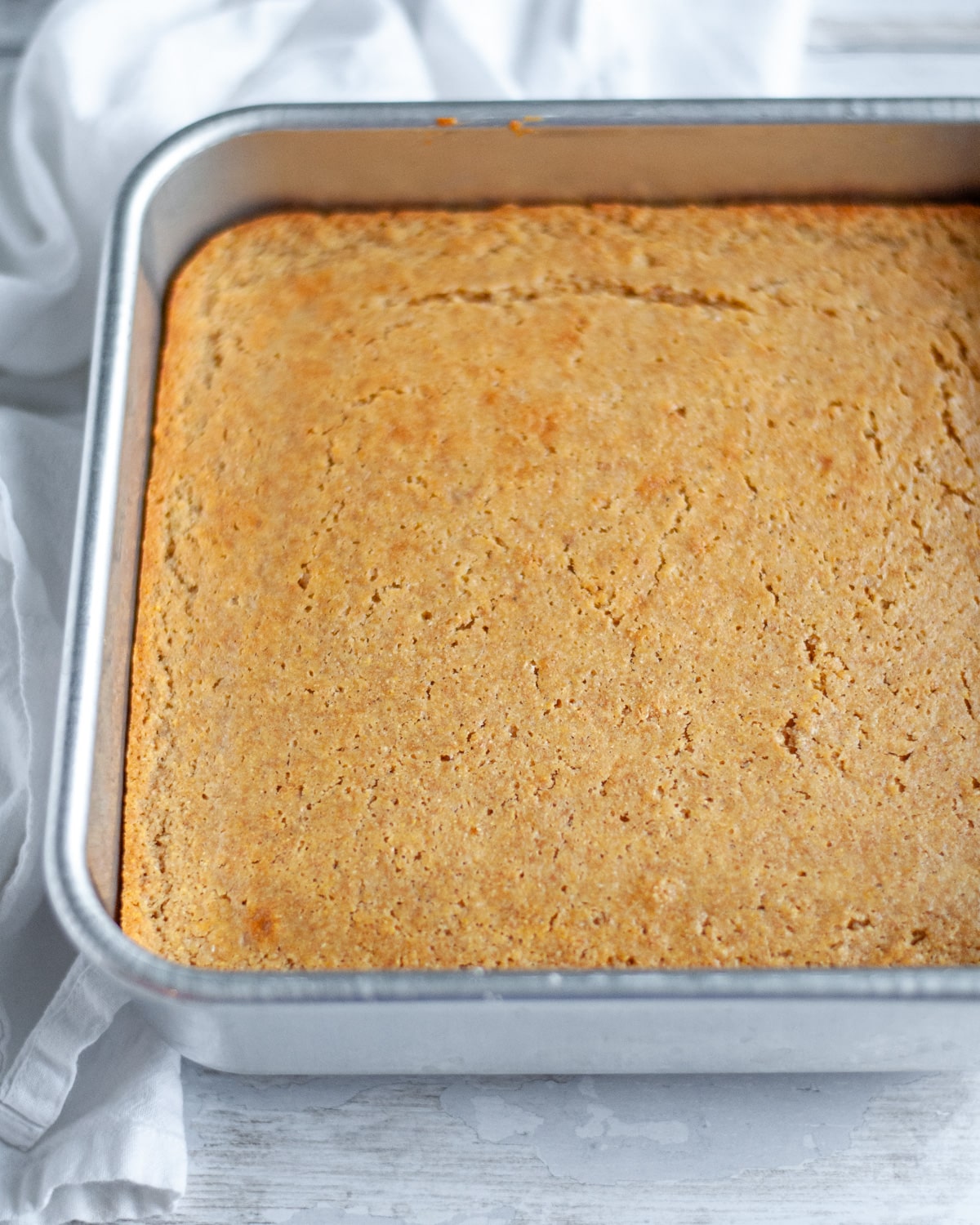 Process shot showing the cornbread baked to golden and fresh out of the oven.