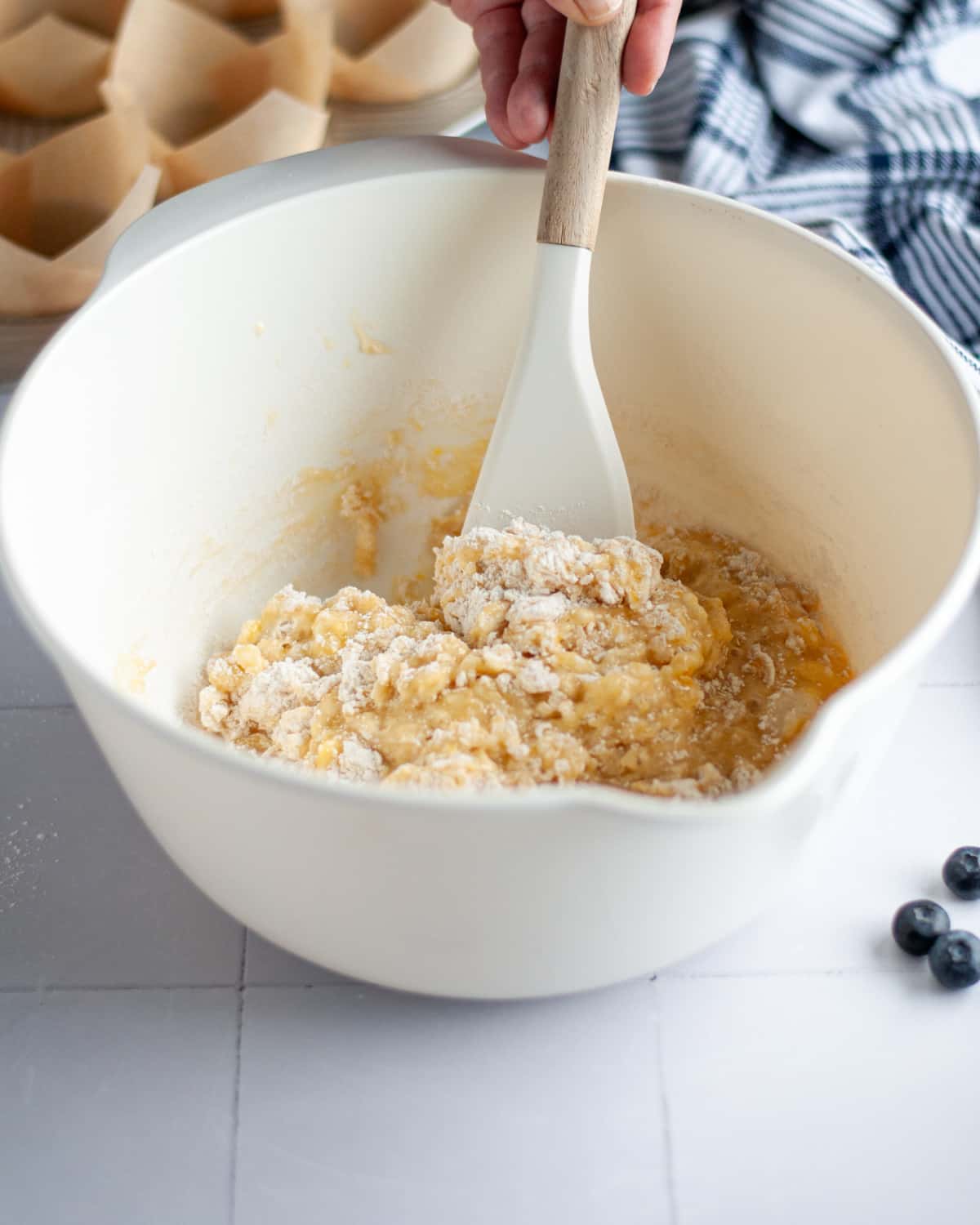 Process shot showing the dry ingredients being stirred in.