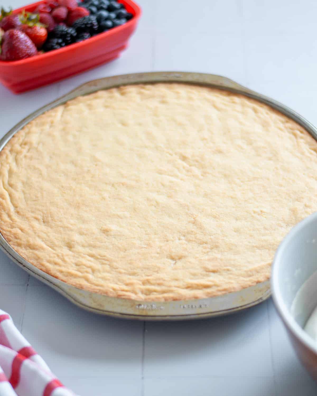 The fruit pizza sugar cookie crust baked until lightly golden and cooled.