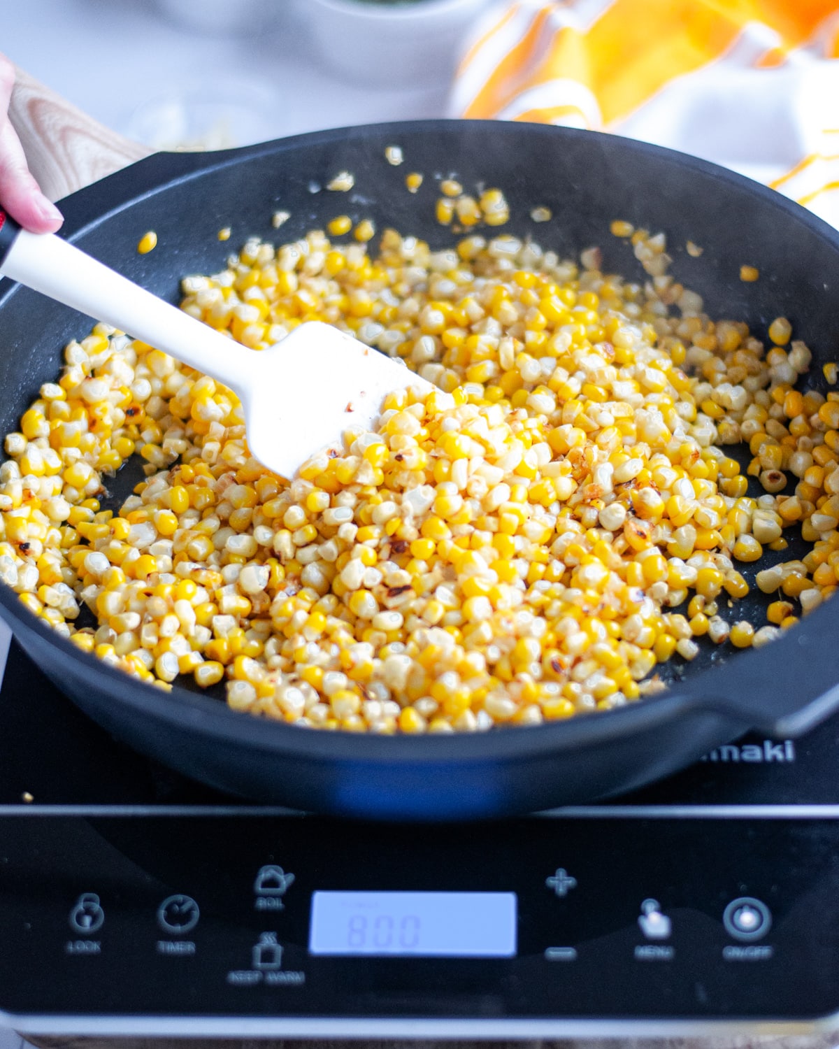 Process shot showing the corn being stirred after the first round of browning.