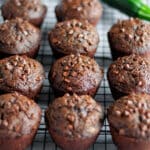 Process shot showing the chocolate muffins with zucchini set onto a wire cooling rack after being baked.
