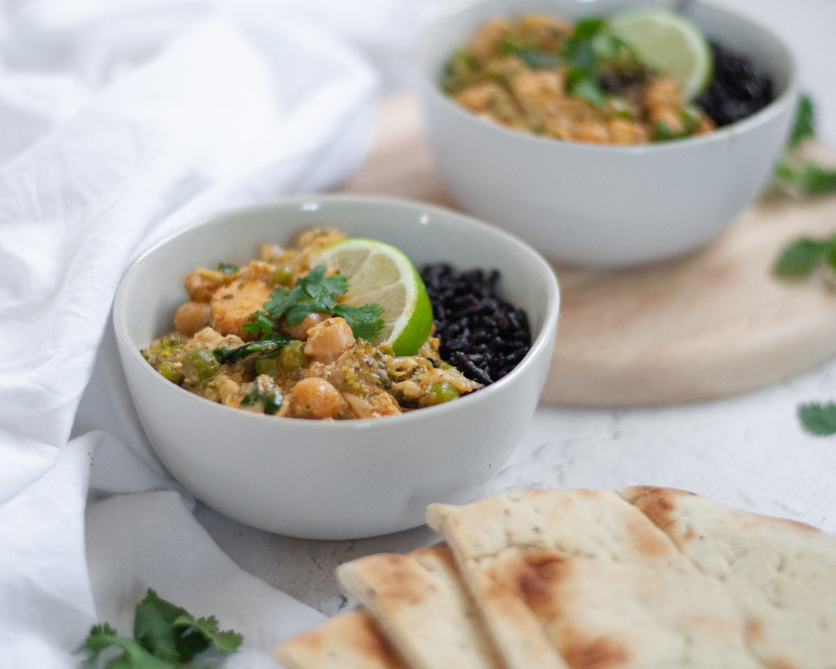 Close up of a bowl filled with our leftover chicken curry over forbidden rice.