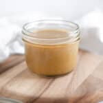 Small jar of maple tahini dressing, showing how this homemade dressing can be stored.