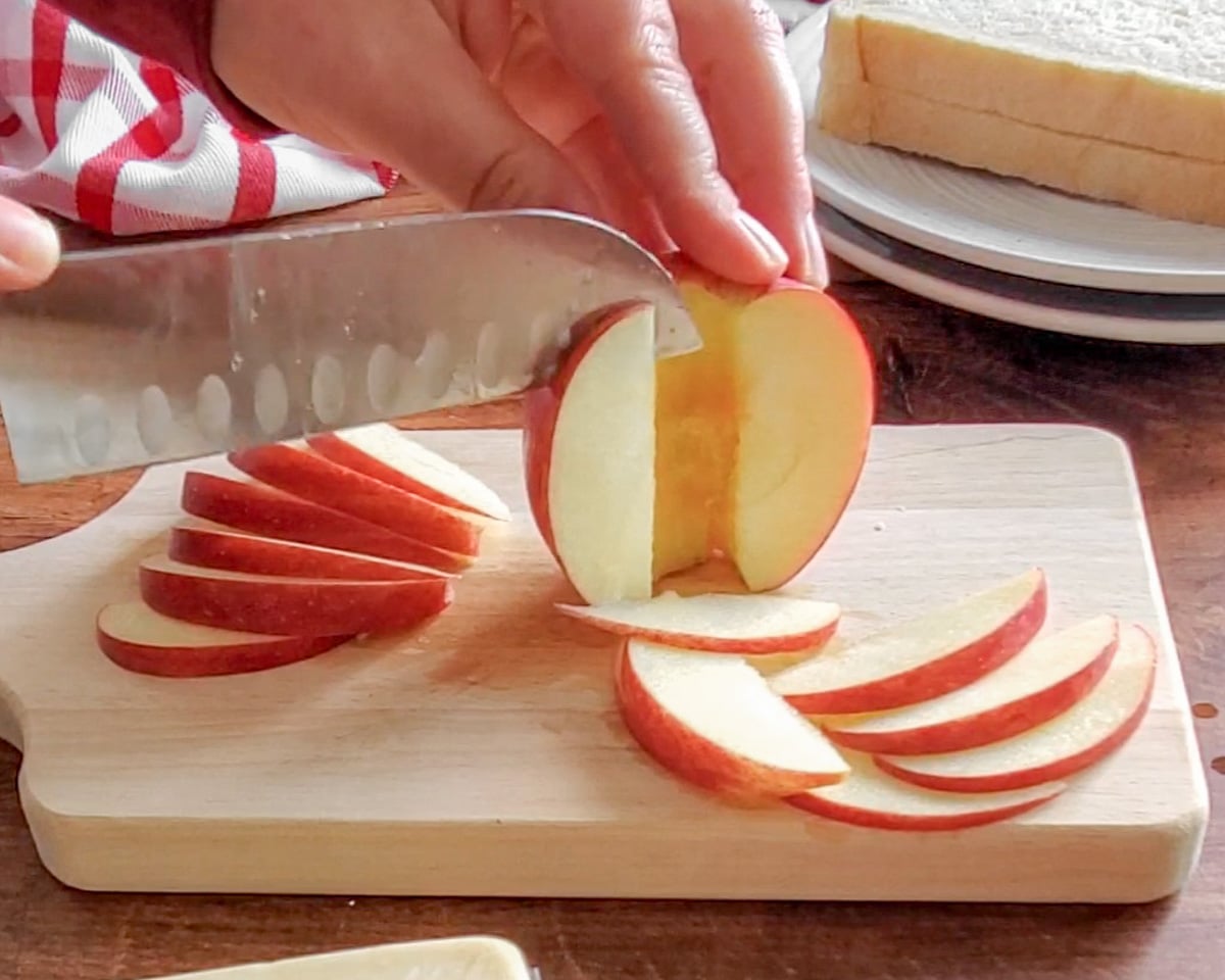 Process shot showing the apple being sliced.