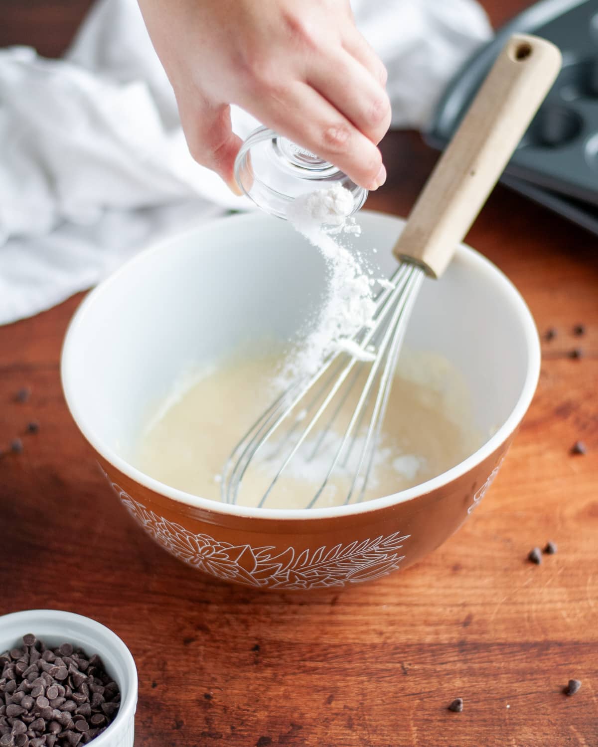 Process shot showing the baking powder, baking soda, and salt being added to the wet ingredients.