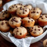 Close up of a bowl filled with chocolate chip mini muffins.