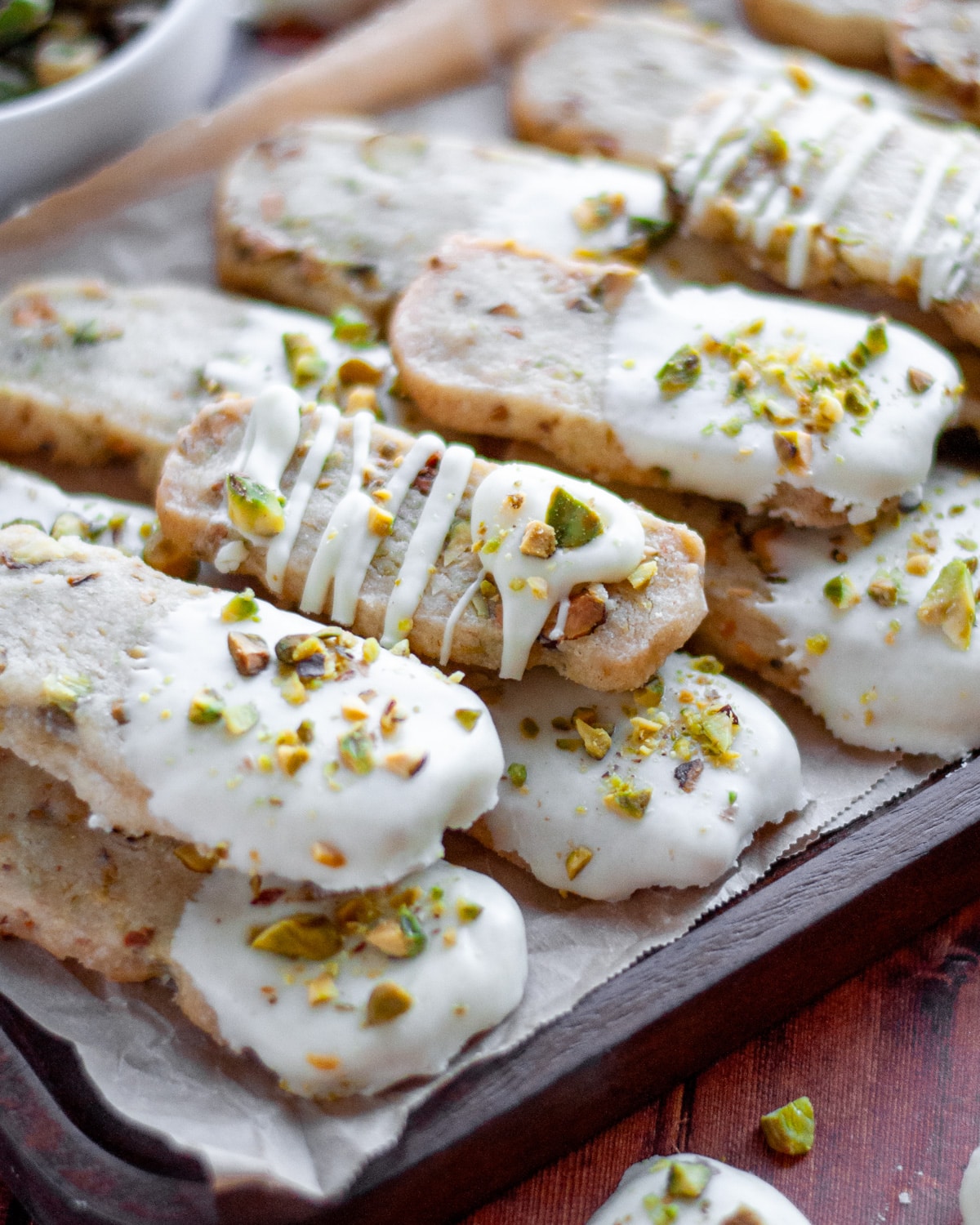 A stack of pistachios shortbread cookies on a serving tray.