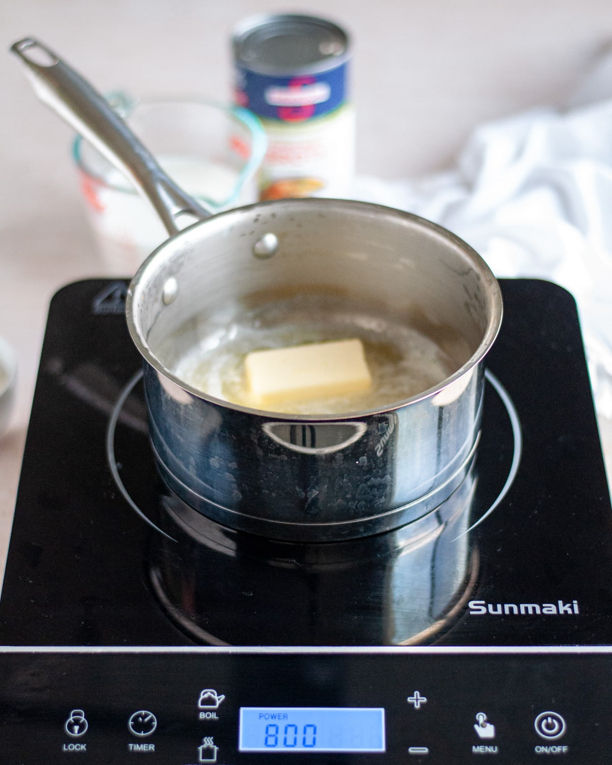 Process shot showing butter being melted in a saucepan for the homemade cream of celery soup.