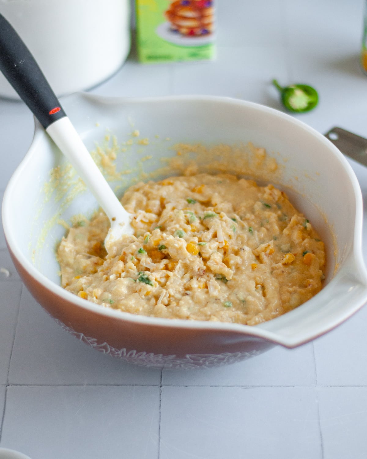 Close up of the finished buttermilk cornbread muffins with jalapenos batter in the mixing bowl.
