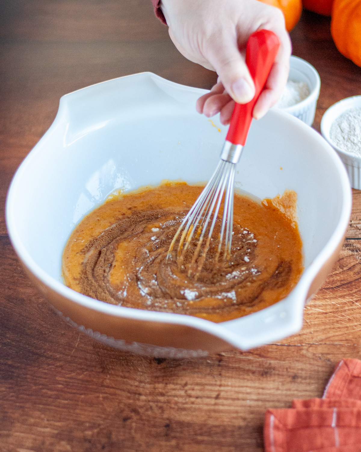 Process shot showing the leavening agents and spices being whisked into the wet ingredients.