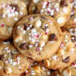 Close up of a pile of peppermint and chocolate chip cookies with candy cane pieces.