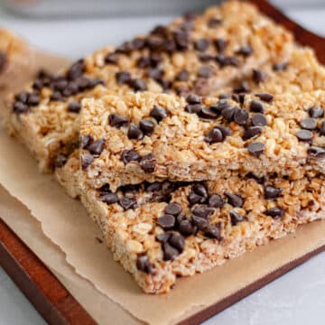 Feature image showing a stack of our easy homemade granola bars on a parchment lined boar.